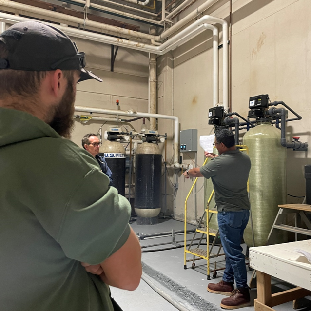 Forest Products Laboratory facility operations specialist Bob Ramos explains how an automated brine capture system works with commercial water softeners.
