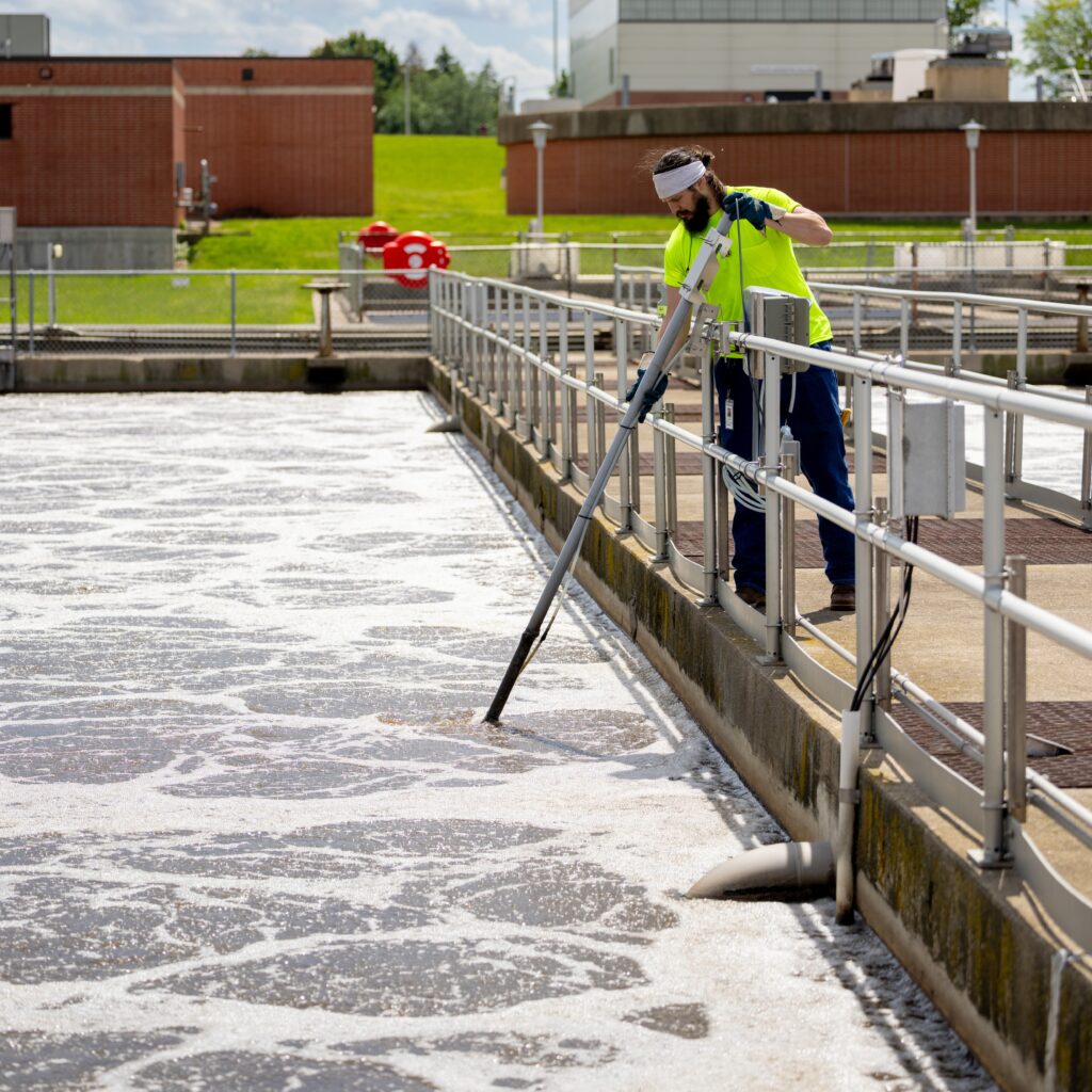 A wastewater operator measures the amount of dissolved oxygen (DO) in the aeration tanks as part of the liquid processing process.