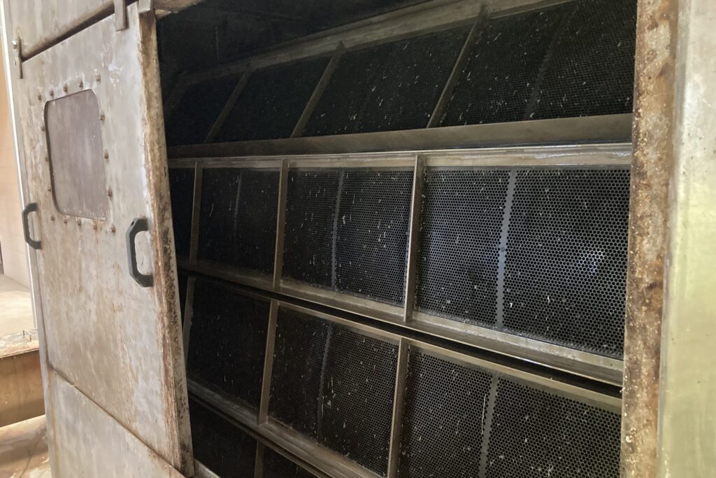 Each screen unit at Headworks consists of panels that slowly rotate down into a chamber filled with wastewater and lift debris up into a trough.