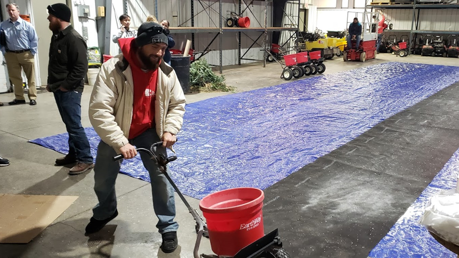 An employee of The Bruce Company tests a drop spreader at a Wisconsin Salt Wise training.