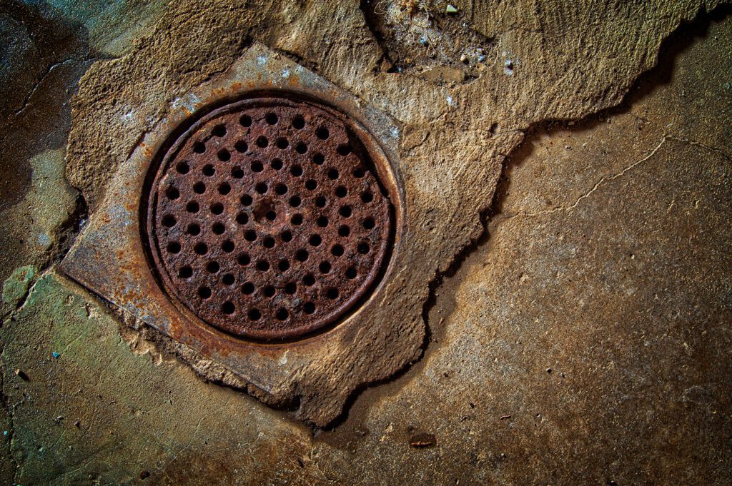 A photo of a home basement drain to represent sewer backups.